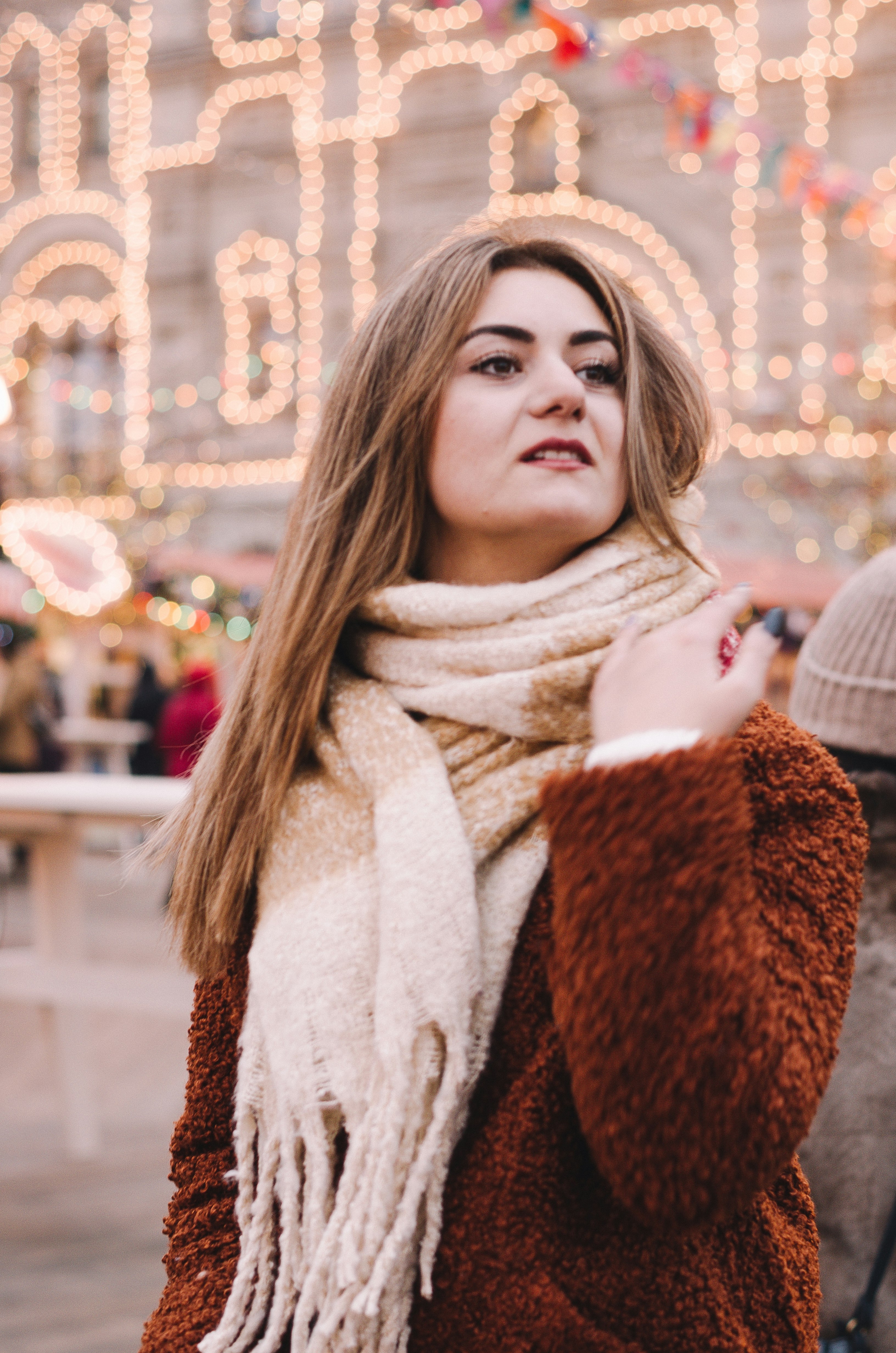 shallow focus photo of woman in brown long-sleeved shirt